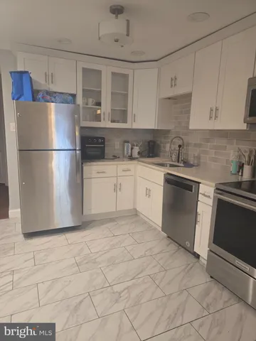 a kitchen with stainless steel appliances granite countertop a refrigerator sink and cabinets