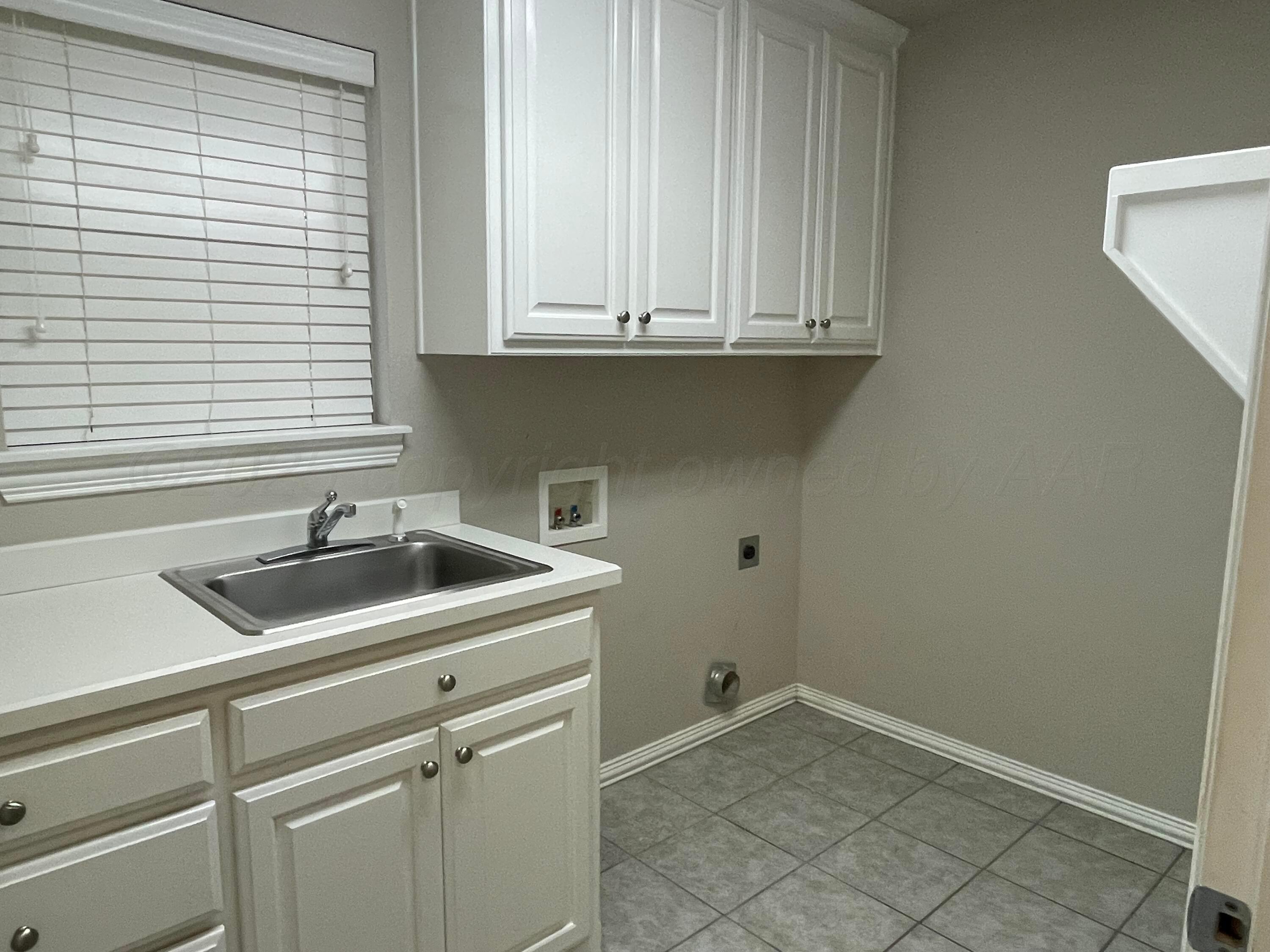 522 Carson Avenue Dumas, TX 79029 - Photo 12 of 18 a view white cabinets and a sink
