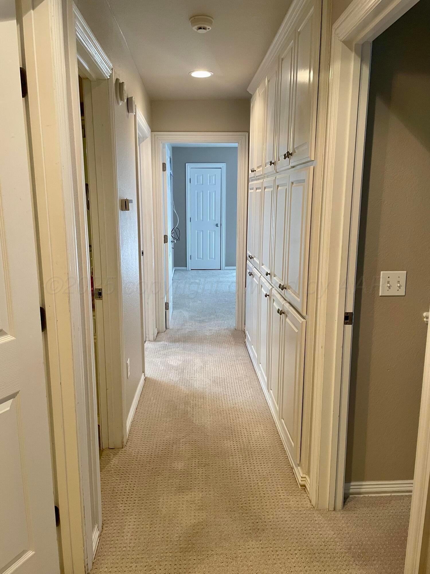522 Carson Avenue Dumas, TX 79029 - Photo 13 of 18 a view of a hallway with wooden door