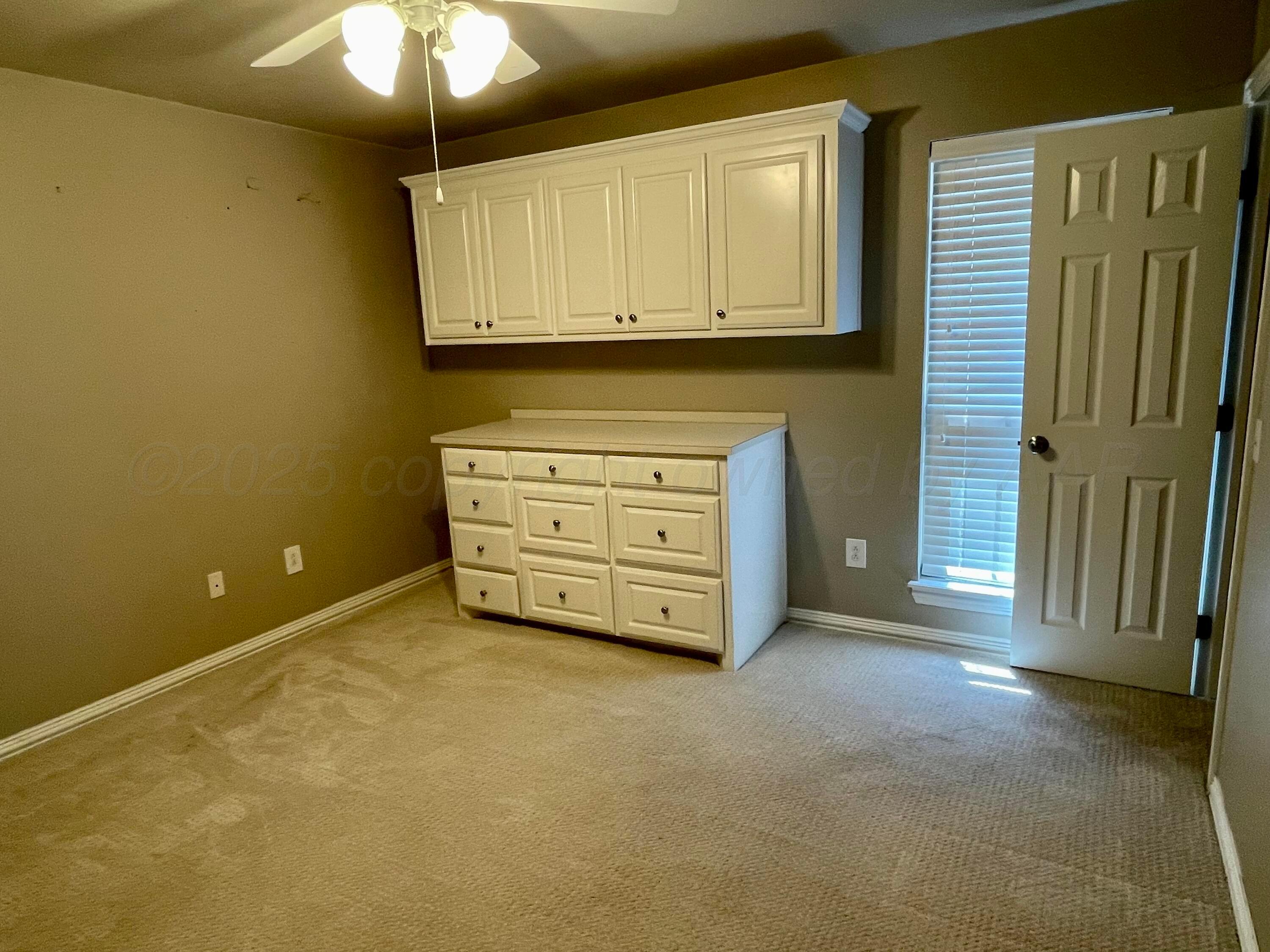 522 Carson Avenue Dumas, TX 79029 - Photo 14 of 18 a view of an empty room with a fireplace