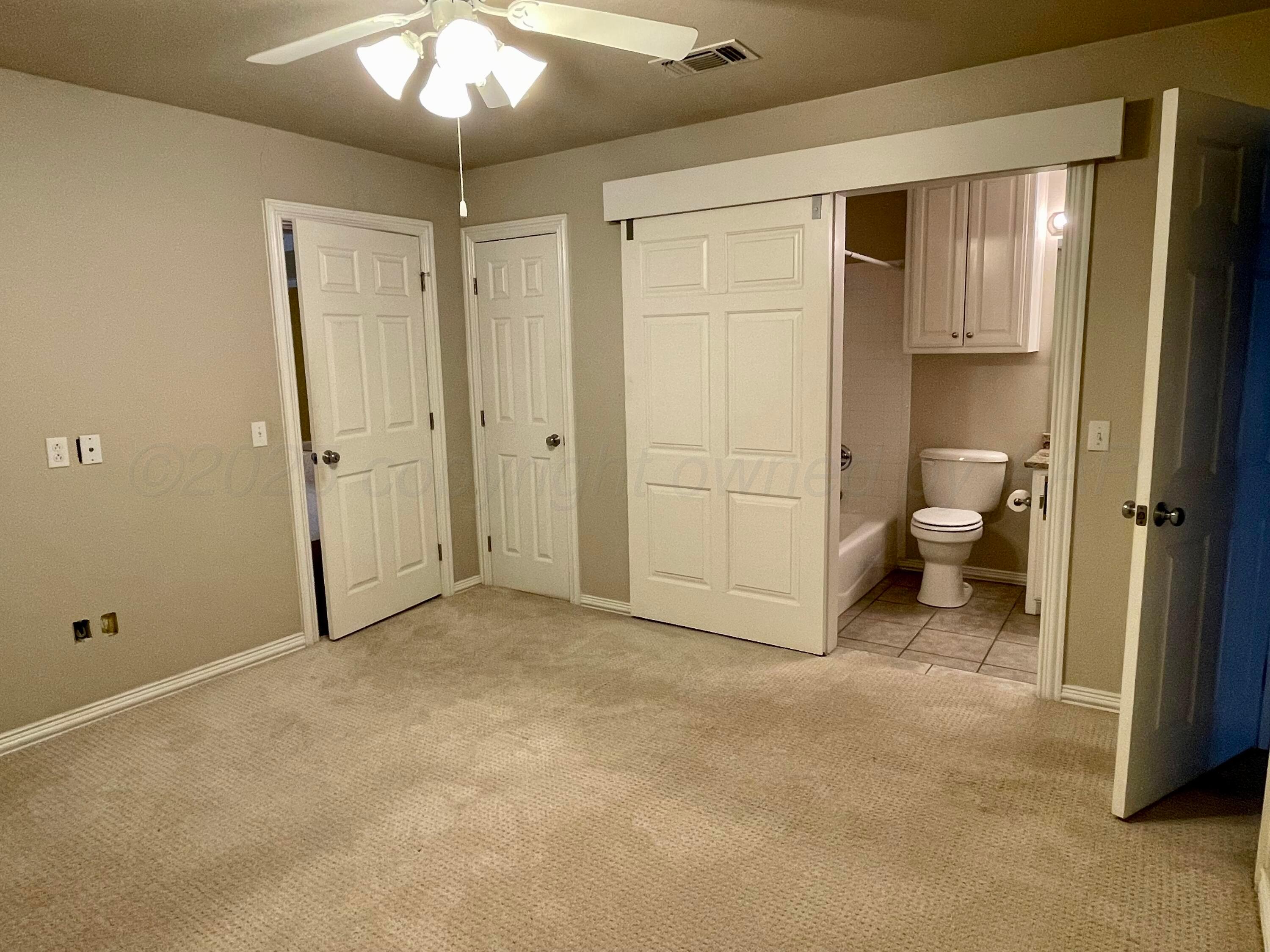 522 Carson Avenue Dumas, TX 79029 - Photo 17 of 18 a view of a room with a ceiling fan and bathroom space
