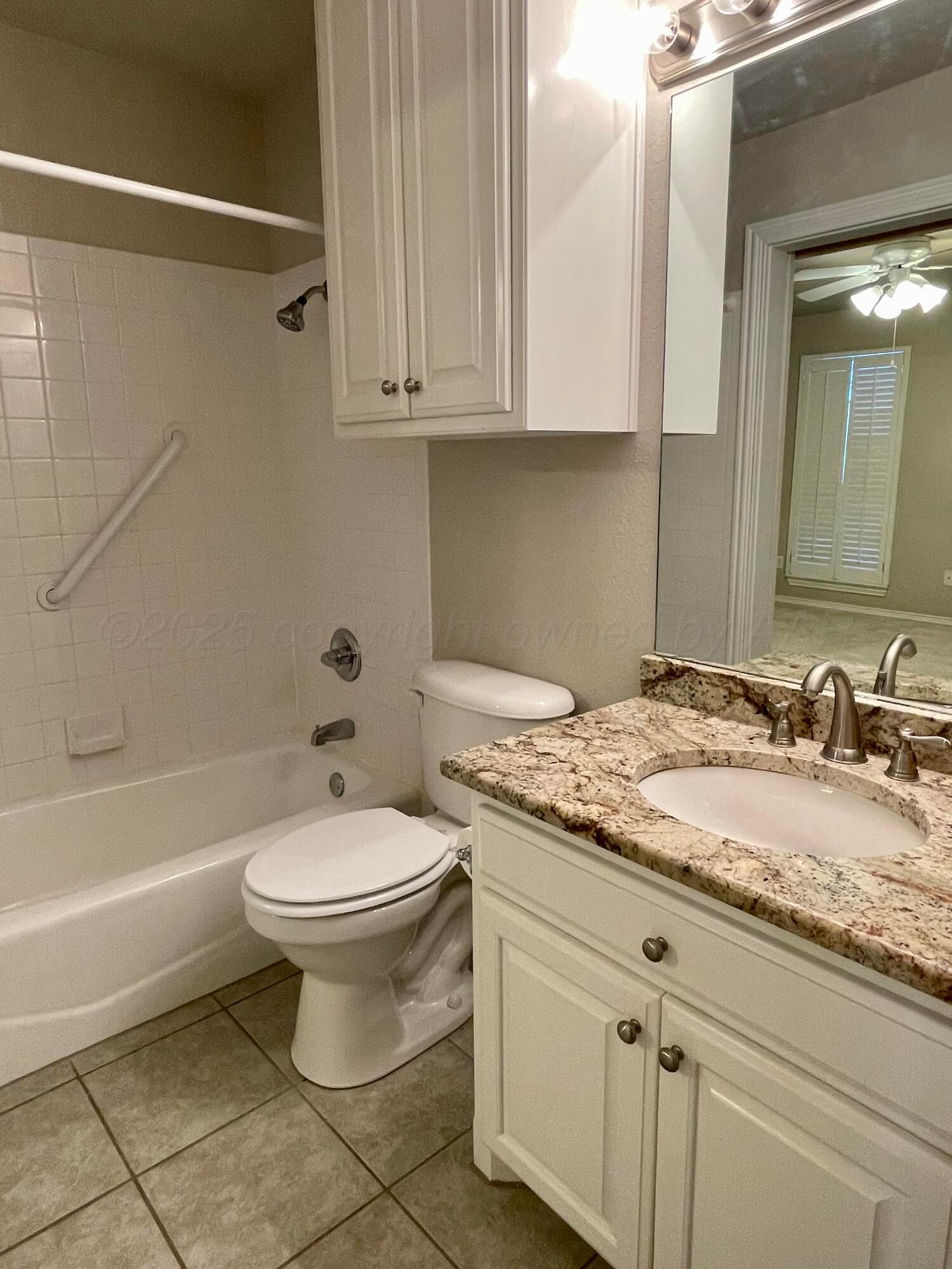 522 Carson Avenue Dumas, TX 79029 - Photo 18 of 18 a bathroom with a granite countertop toilet a sink and bathtub