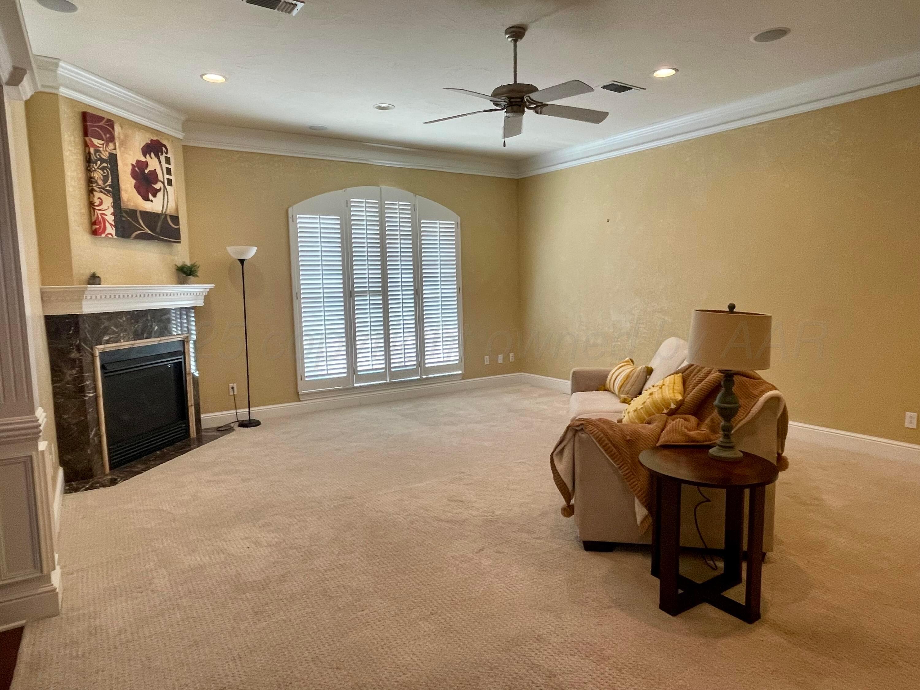 522 Carson Avenue Dumas, TX 79029 - Photo 2 of 18 a living room with furniture and a fireplace