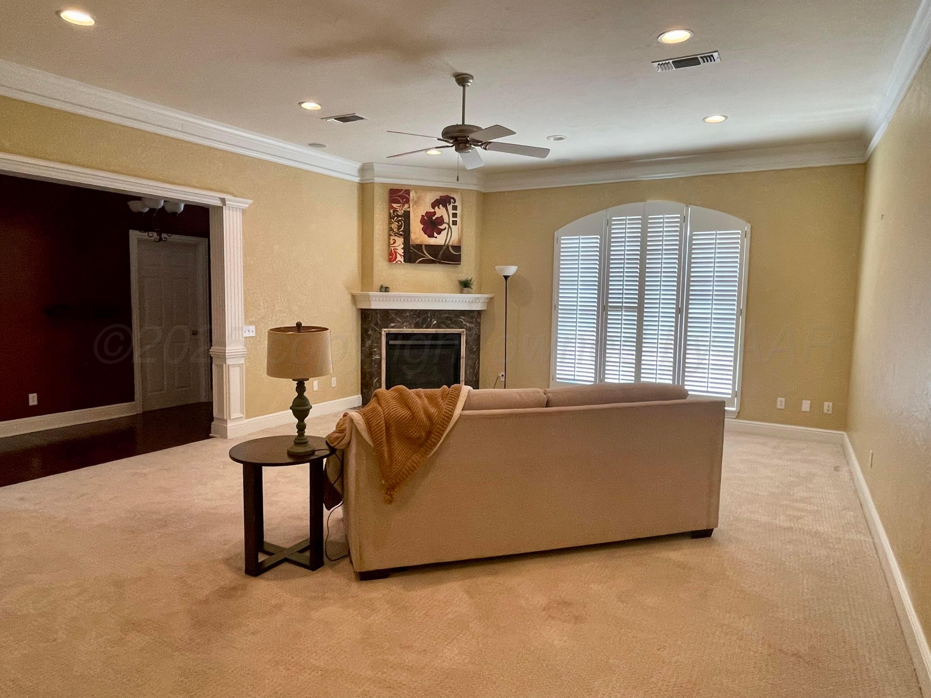 522 Carson Avenue Dumas, TX 79029 - Photo 3 of 18 a living room with furniture and a fireplace