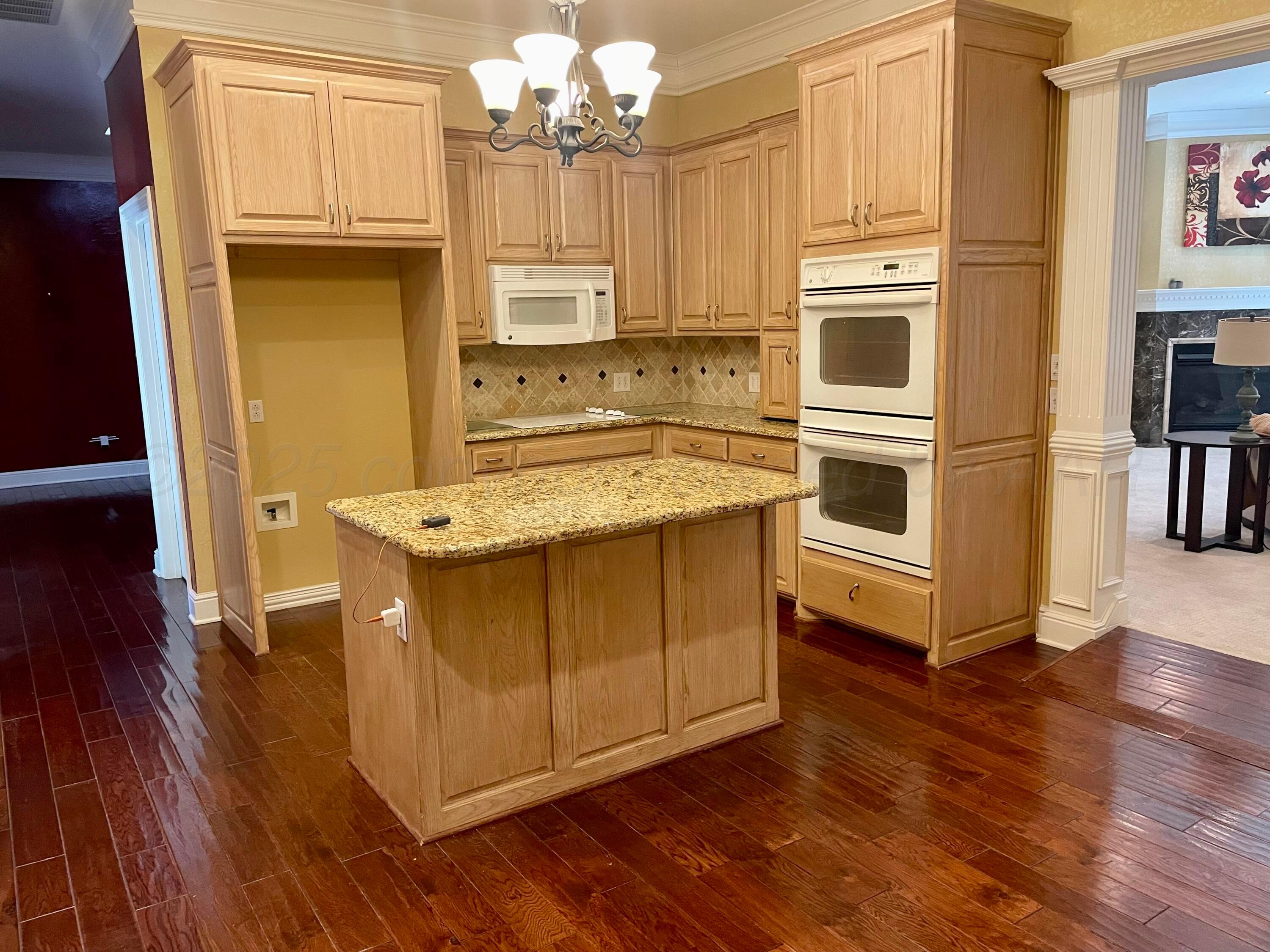 522 Carson Avenue Dumas, TX 79029 - Photo 5 of 18 a kitchen with stainless steel appliances a stove top oven and a refrigerator