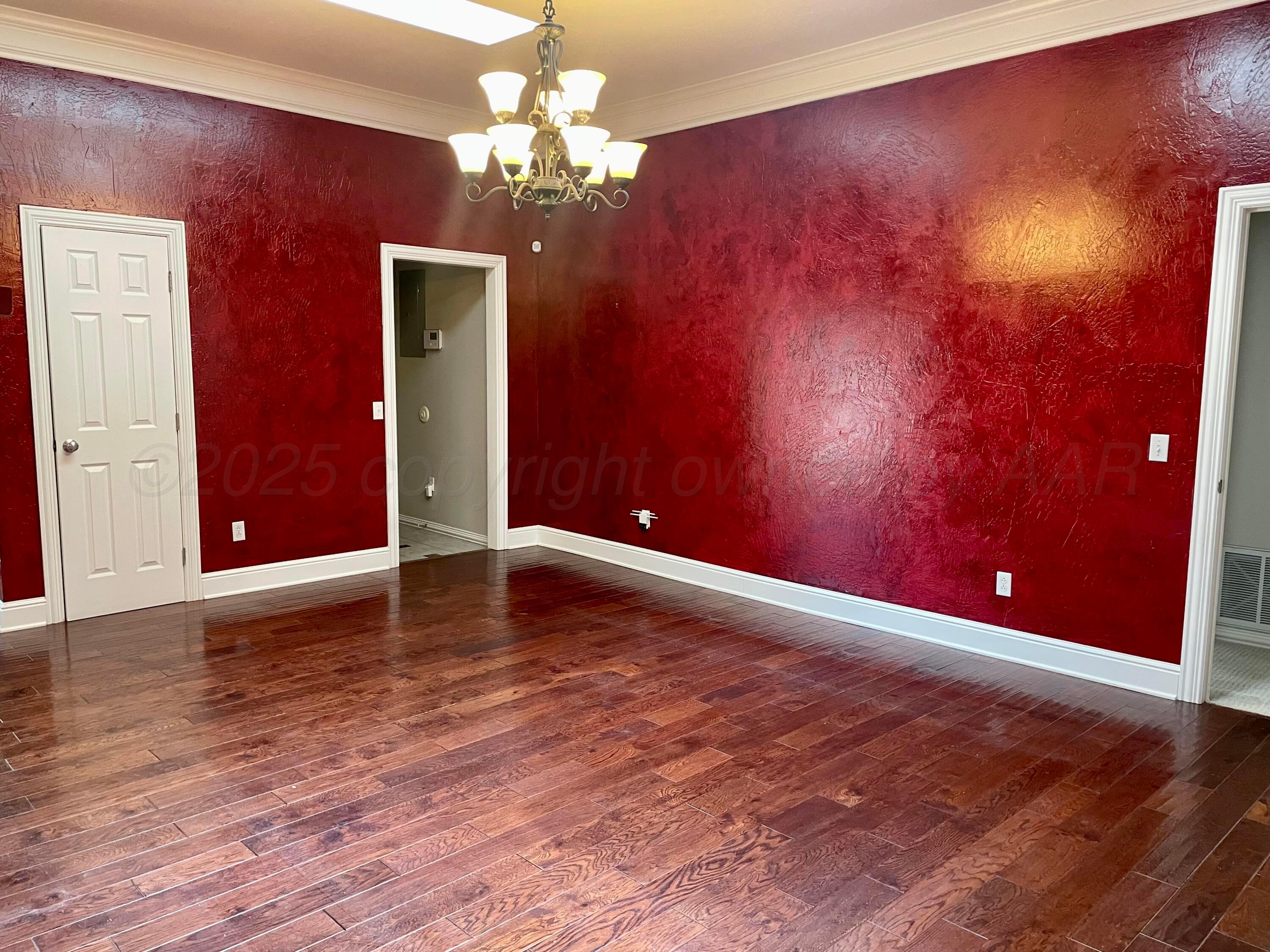 522 Carson Avenue Dumas, TX 79029 - Photo 6 of 18 a view of a livingroom with a chandelier fan and fire place
