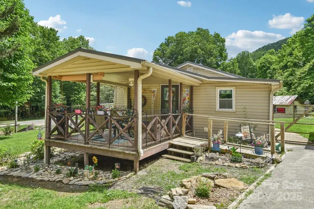 a view of a house with backyard tub and sitting area