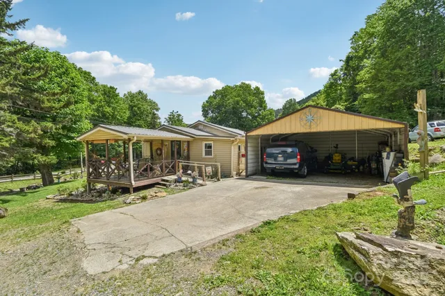 a view of a house with a patio and a yard
