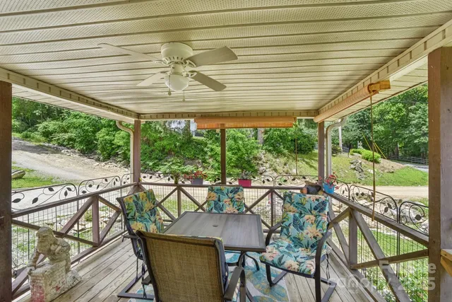 a view of a patio with table and chairs and wooden floor