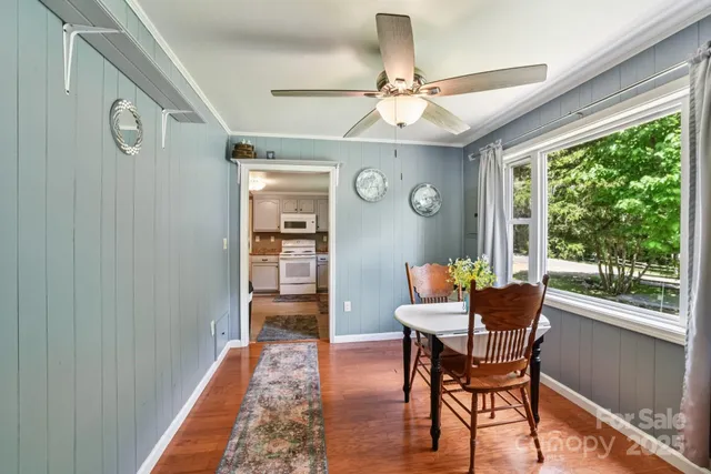 a dining room with furniture window and wooden floor