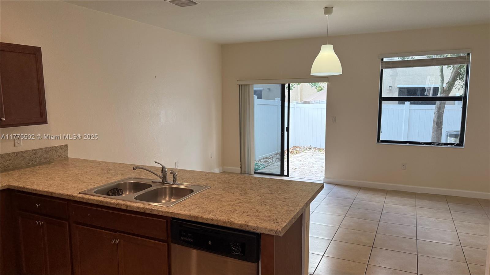 9213 West 33rd Way Hialeah, FL 33018 - Photo 4 of 13 a kitchen with a sink cabinets and a window