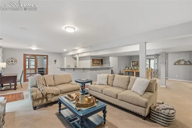 a view of a roof deck with table and chairs couches with wooden floor and fence