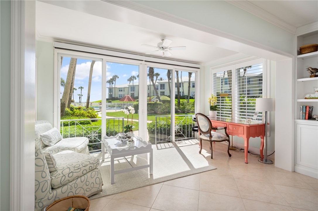 1180 Reef Road, Unit B7 Vero Beach, FL 32963 - Photo 7 of 28 a living room filled with furniture and a large window