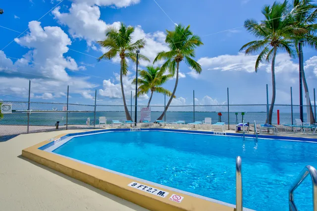 a view of a swimming pool with a table and chairs