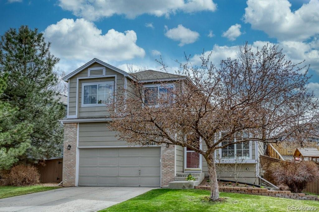 9561 South Castle Ridge Circle Highlands Ranch, CO 80129 - Photo 2 of 29 a front view of a house with a garden