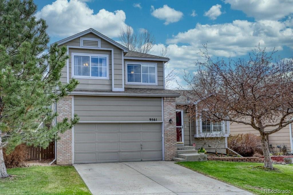 9561 South Castle Ridge Circle Highlands Ranch, CO 80129 - Photo 3 of 29 a front view of a house with a garden