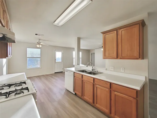 a kitchen with a sink stove and cabinets