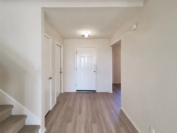 a view of hallway with wooden floor