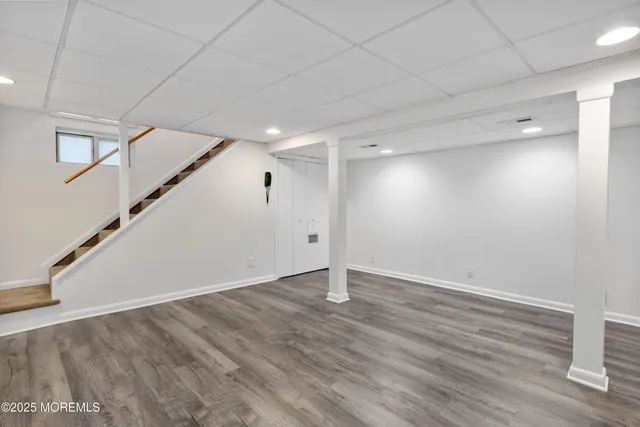 an empty room with wooden floor and white walls