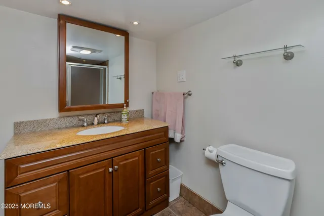 a bathroom with a sink a toilet and mirror