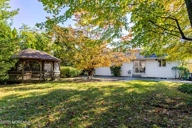 a view of a house with swimming pool and sitting area