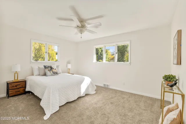 a bedroom with a bed and a potted plant