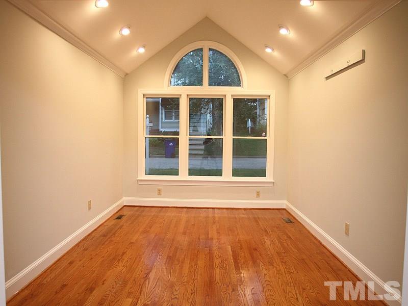 2109 Camrose Street Raleigh, NC 27608 - Photo 2 of 12 an empty room with wooden floor and windows