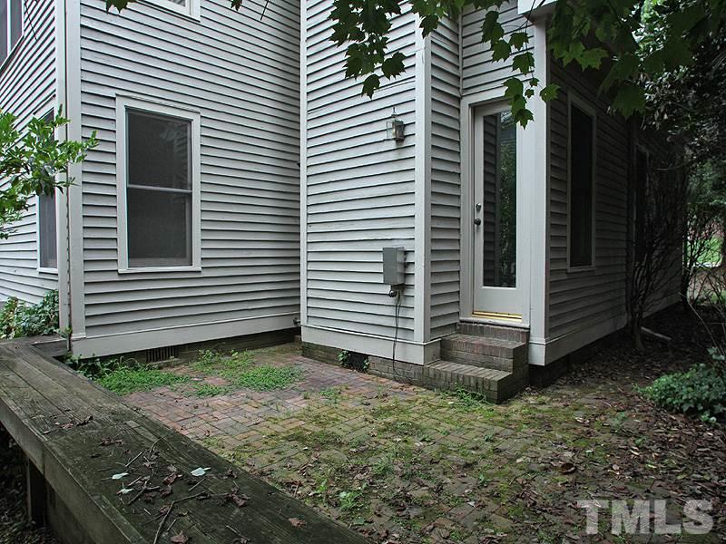 2109 Camrose Street Raleigh, NC 27608 - Photo 11 of 12 a view of a house with a yard and garage