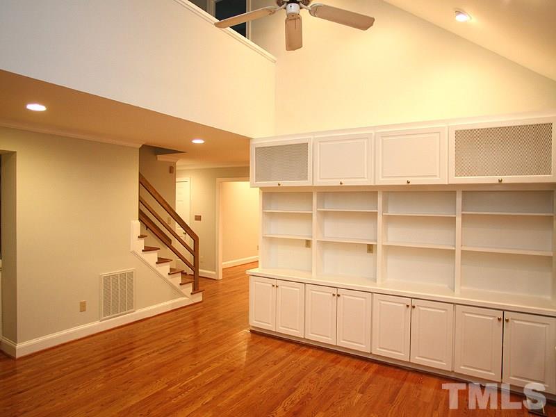 2109 Camrose Street Raleigh, NC 27608 - Photo 5 of 12 a view of a livingroom with an empty space and wooden floor