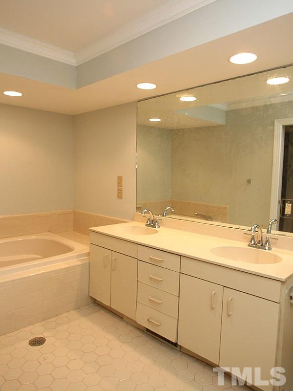 2109 Camrose Street Raleigh, NC 27608 - Photo 7 of 12 a bathroom with a tub sink and mirror