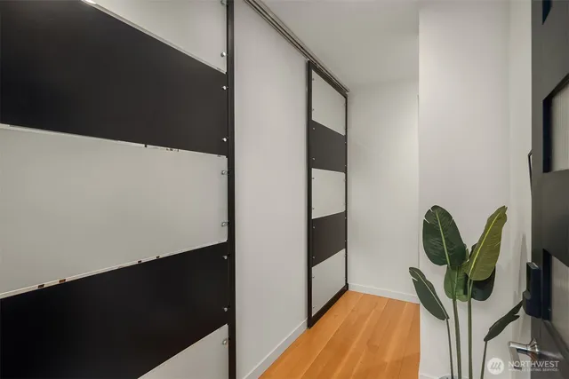 a view of a hallway with wooden floor