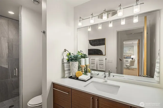a bathroom with a sink a toilet and mirror