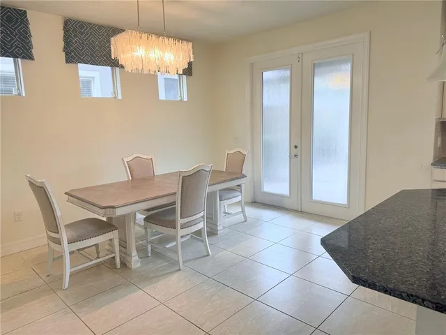 a dining room with furniture and chandelier