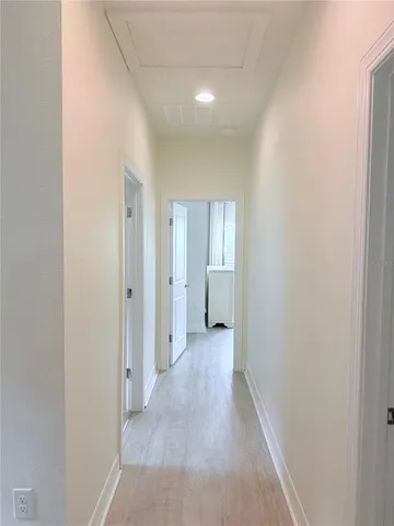 a view of a hallway with wooden floor