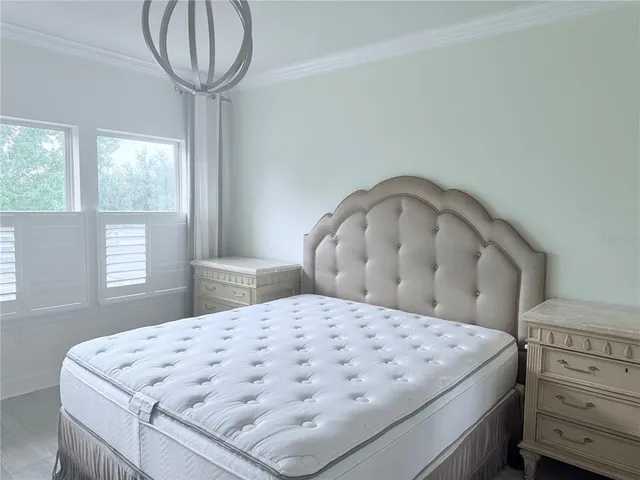 a bed sitting in a bedroom next to a window