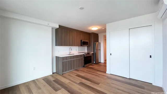 a kitchen with a sink a stove and cabinets