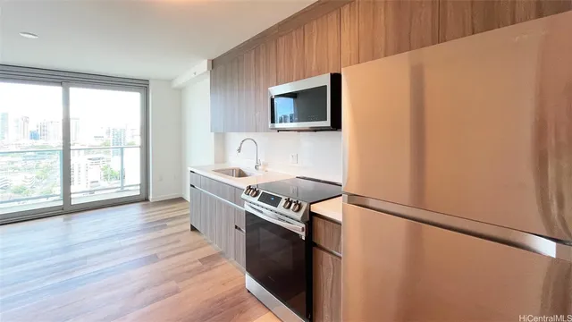 a kitchen with stainless steel appliances a microwave a stove and a refrigerator