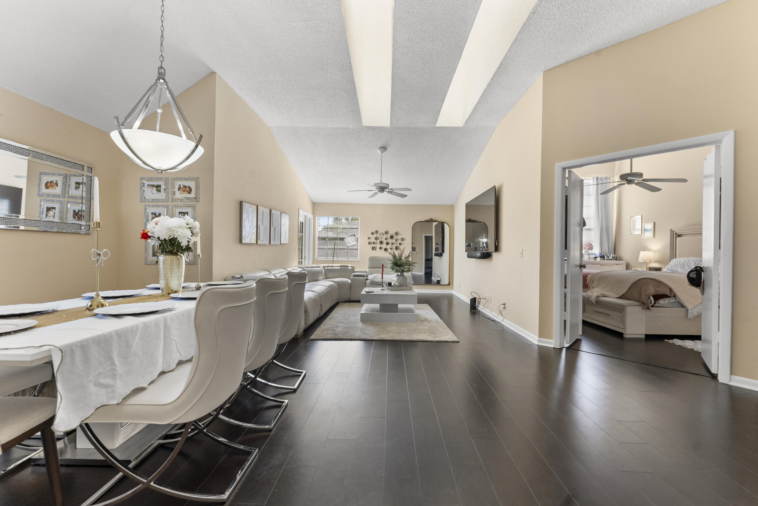 5359 Buckhead Circle, Unit 2031 Boca Raton, FL 33431 - Photo 20 of 25 a view of a dining room with furniture wooden floor and a chandelier
