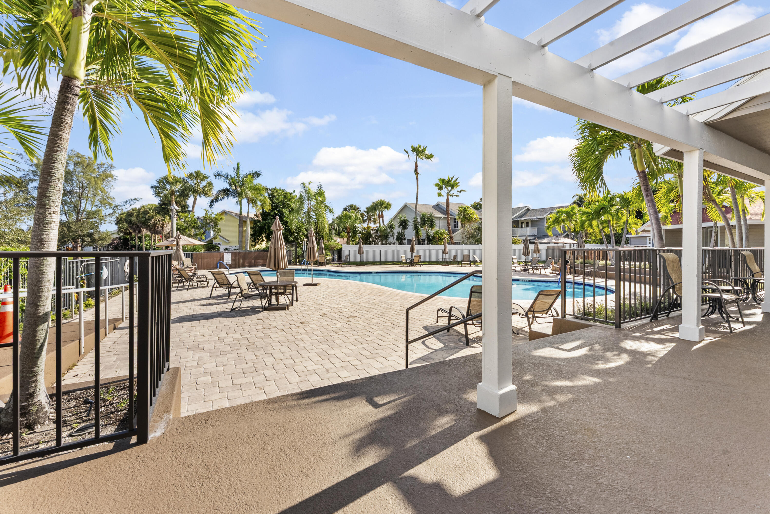 5359 Buckhead Circle, Unit 2031 Boca Raton, FL 33431 - Photo 23 of 25 a view of a swimming pool with a patio