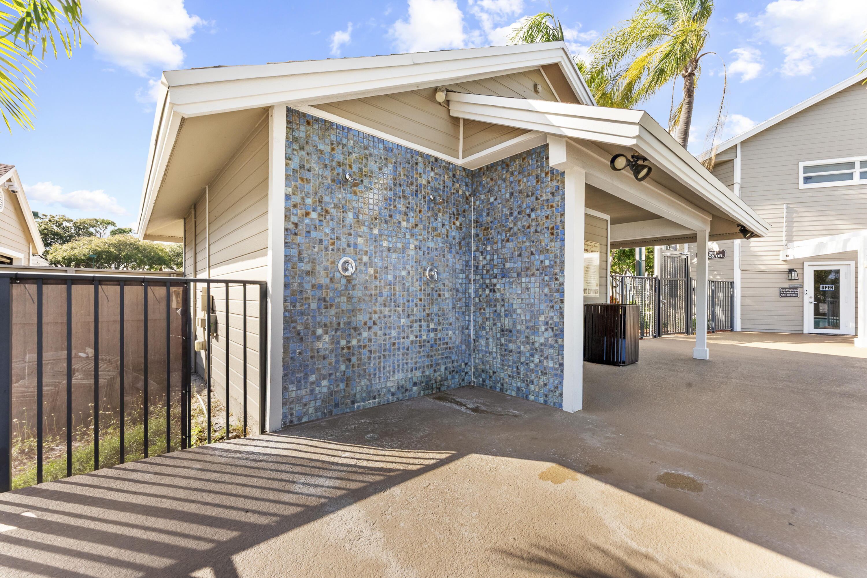 5359 Buckhead Circle, Unit 2031 Boca Raton, FL 33431 - Photo 24 of 25 a view of a patio with table and chairs with wooden fence and plants