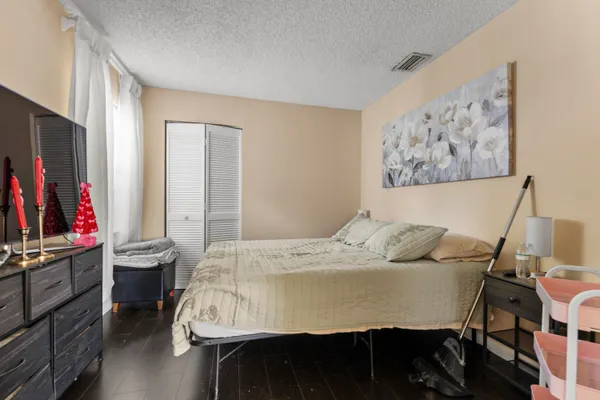 a bed sitting in a bedroom next to a window