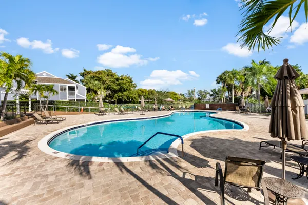 a swimming pool with outdoor seating and yard