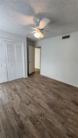 a view of an empty room with a ceiling fan