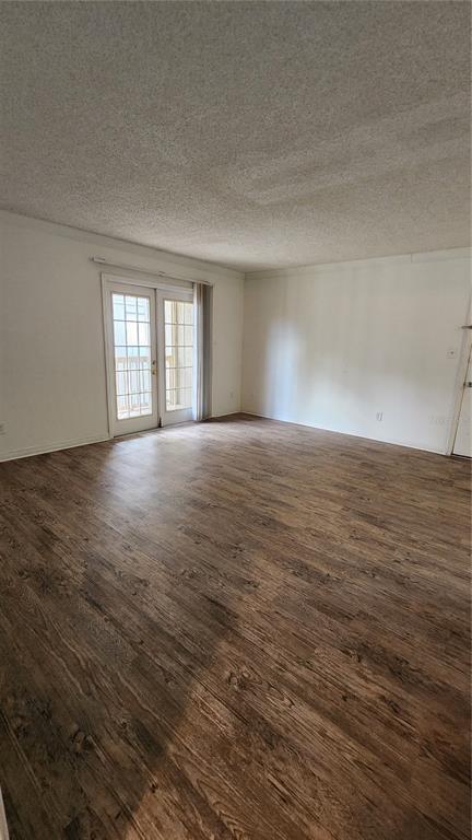 285 Wymore Road, Unit 207 Altamonte Springs, FL 32714 - Photo 4 of 17 a view of an empty room with window and wooden floor