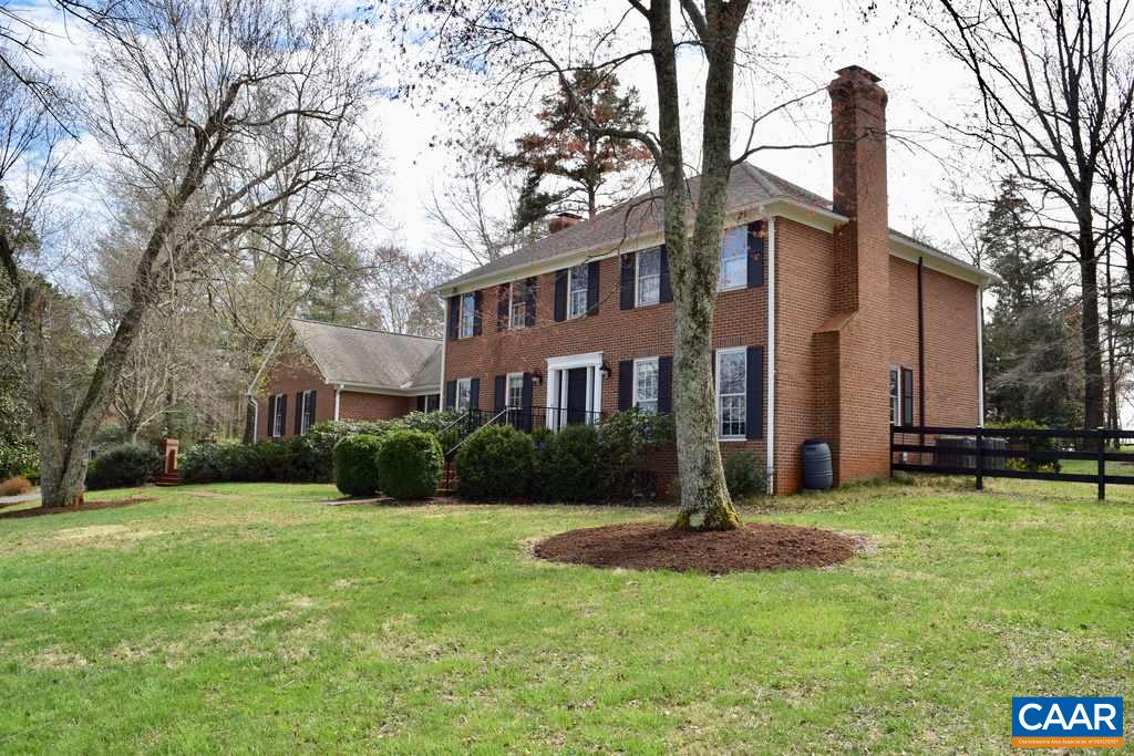 1660 Old Ballard Road Charlottesville, VA 22901 - Photo 1 of 1 a front view of a house with garden and trees