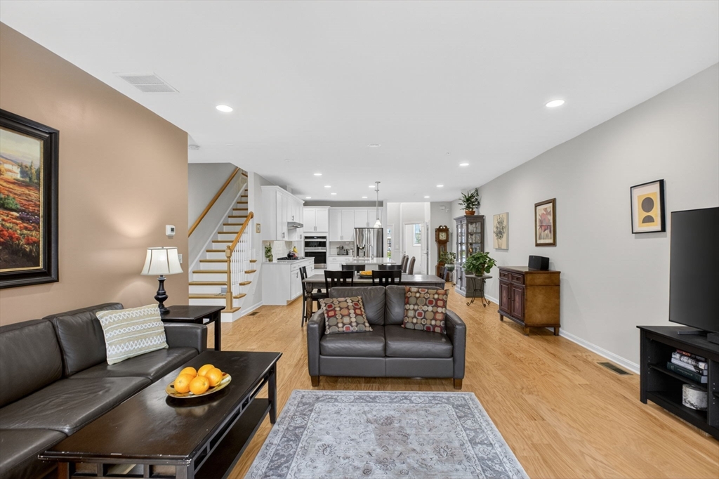 87 Shannon Way, Unit 86 Upton, MA 01568 - Photo 4 of 36 a living room with furniture fireplace and kitchen view