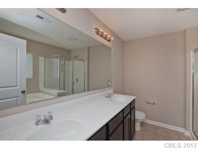 2211 Durand Road, Unit 77 Fort Mill, SC 29715 - Photo 14 of 16 a bathroom with a sink vanity and a mirror