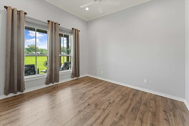 a bathroom with a granite countertop double vanity sink and a mirror