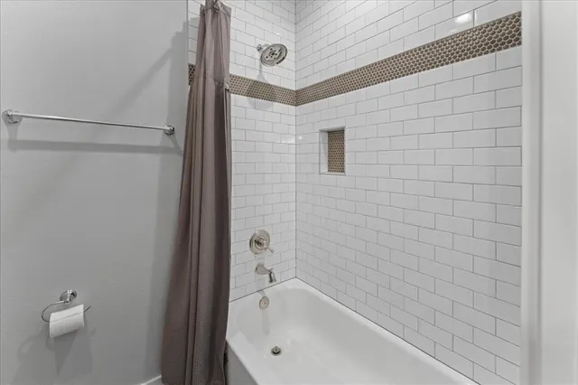 a view of a livingroom with furniture wooden floor and windows