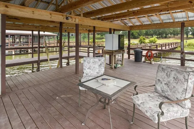 a picture of a room with windows and refrigerator